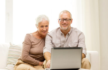 family, technology, age and people concept – happy senior couple